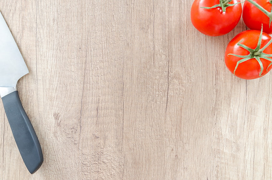 Fresh Tomatoes and Knife on Wooden Table with Copyspace