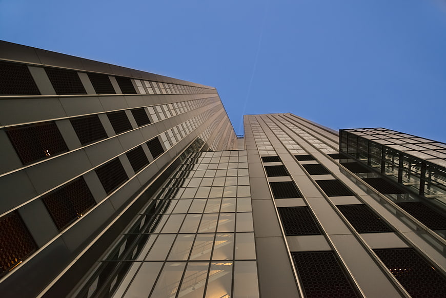 Low angle view of modern skyscrapers against blue sky