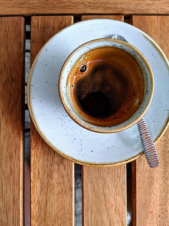 Top view of espresso in ceramic cup on wooden table