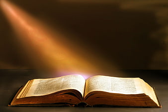 Old Open Book with Magical Light Beam