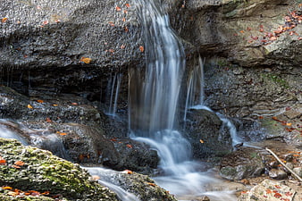 Serene Autumn Waterfall with Long Exposure Flowing Water