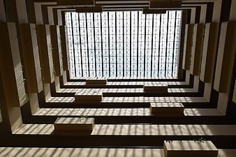 Modern architectural atrium with geometric skylight and shadows
