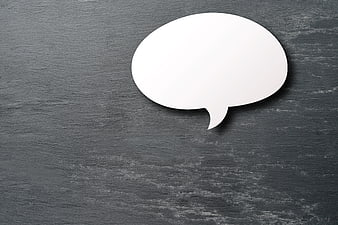 White speech bubble cutout on dark slate background