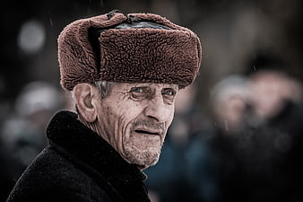 Portrait of elderly man in brown fur ushanka hat