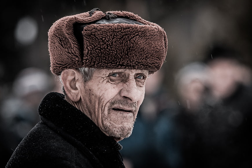 Portrait of elderly man in brown fur ushanka hat