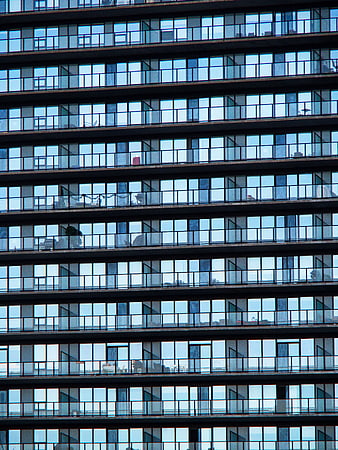 Modern glass building facade with repeating window pattern