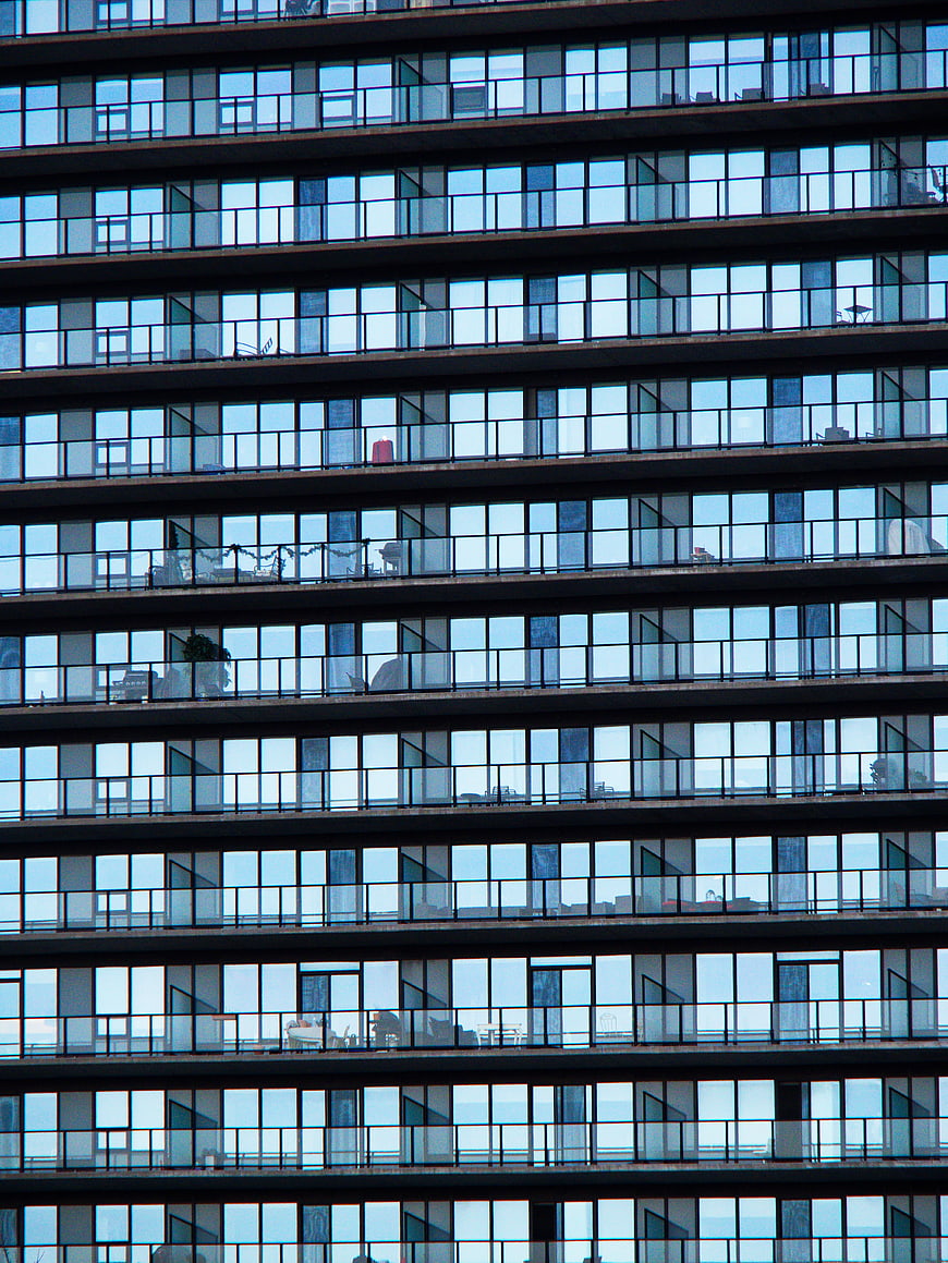 Modern glass building facade with repeating window pattern