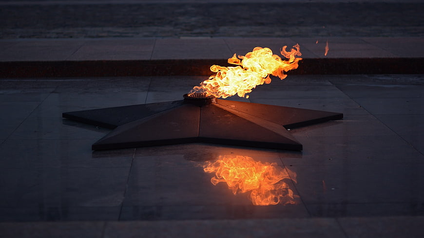 Eternal flame on star monument at dusk