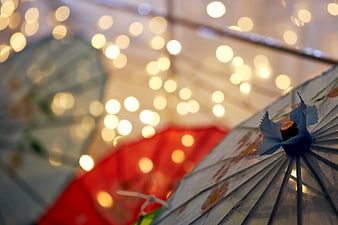 Colorful Paper Parasols with Bokeh Lights Background