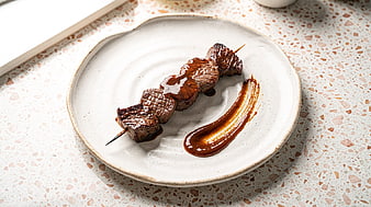 Grilled Beef Skewers with Glazed Sauce on Ceramic Plate