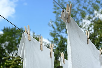 White Linen Laundry Drying on Clothesline Outdoors