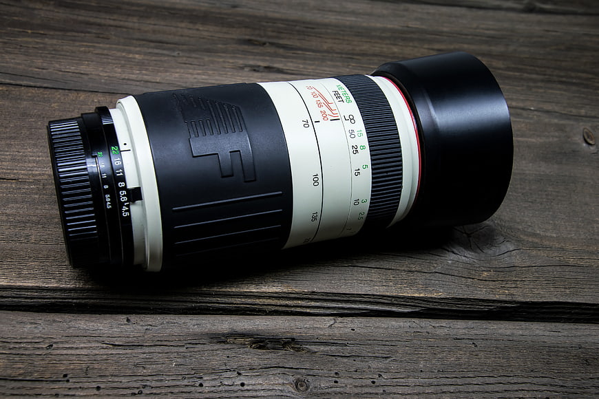 Vintage Canon FD Telephoto Lens on Rustic Wood