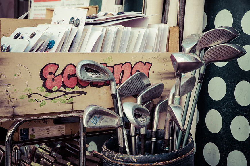 Used Golf Clubs in Bucket at Flea Market Stall