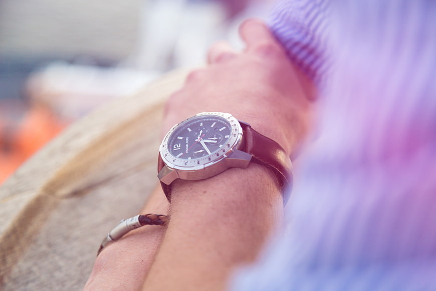 Close-up of wristwatch on man's arm with blurred background