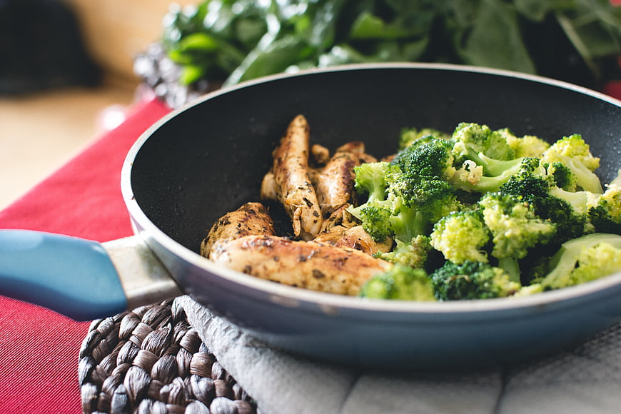 Pan-fried chicken breast and broccoli in a skillet