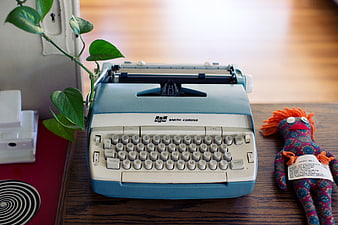 Vintage Smith-Corona Typewriter on Wooden Desk with Plant