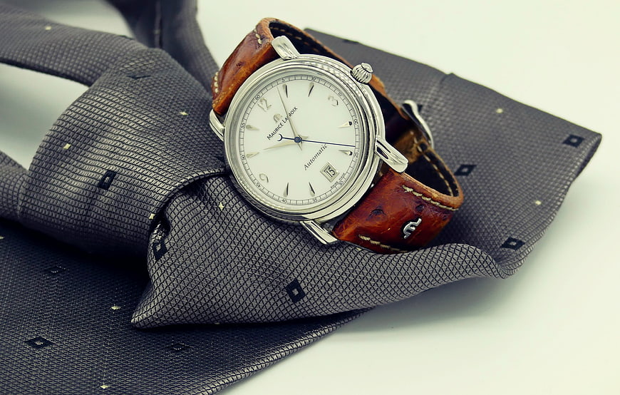 Elegant Silver Watch on Textured Grey Tie