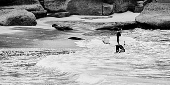 Surfer Walking into Ocean with Surfboard