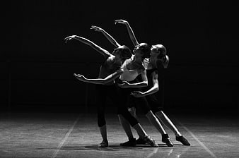 Three female dancers performing contemporary dance in black and white