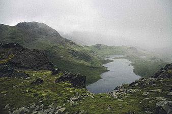 Misty Mountain Lake Landscape with Green Hills and Rocks