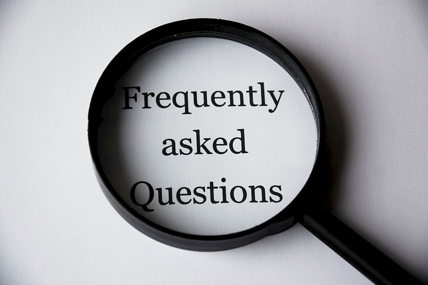 Magnifying glass over frequently asked questions text
