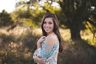 Smiling Brunette Woman in Lace Top Outdoors