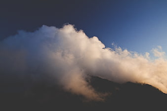 Dramatic Clouds Over Mountain Peak at Sunset