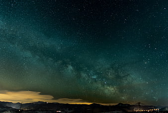 Milky Way Galaxy Over Snowy Mountain Range at Night