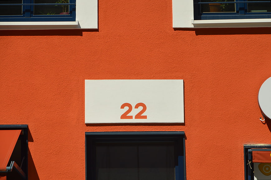 Orange building facade with white house number 22