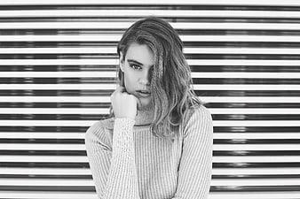 Black and white portrait of woman against striped background