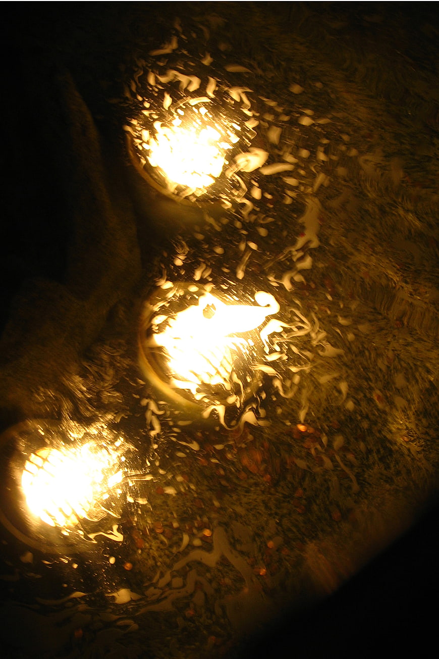 Abstract golden lights through raindrops on glass at night