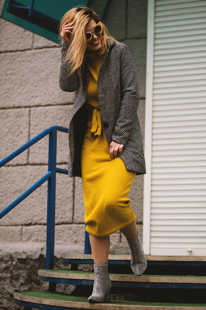 Happy Woman in Yellow Dress and Sunglasses Walking Down Stairs