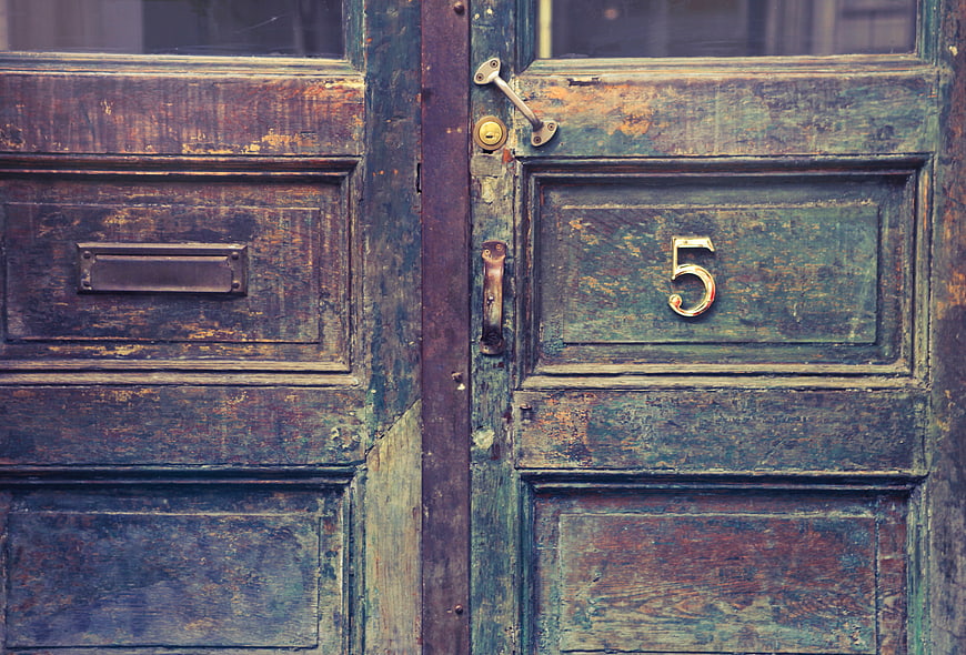 Vintage Weathered Wooden Door with Number Five and Letterbox