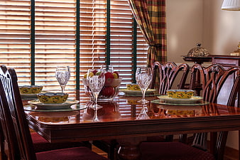 Elegant dining room table set with fruit and crystal glassware