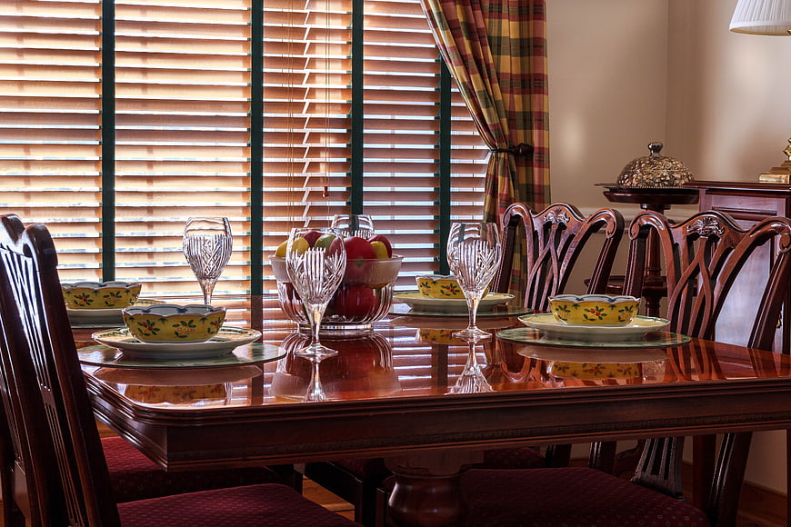 Elegant dining room table set with fruit and crystal glassware