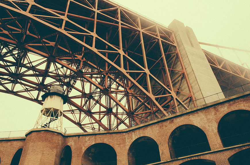 Low angle view of steel bridge truss and brick arches