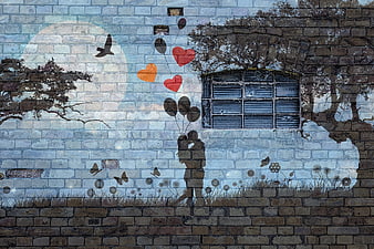 Romantic street art mural of couple with heart balloons on brick wall