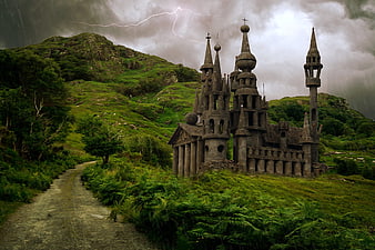 Fantasy stone castle on green hill with lightning storm