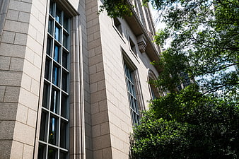 Low angle view of beige stone office building facade
