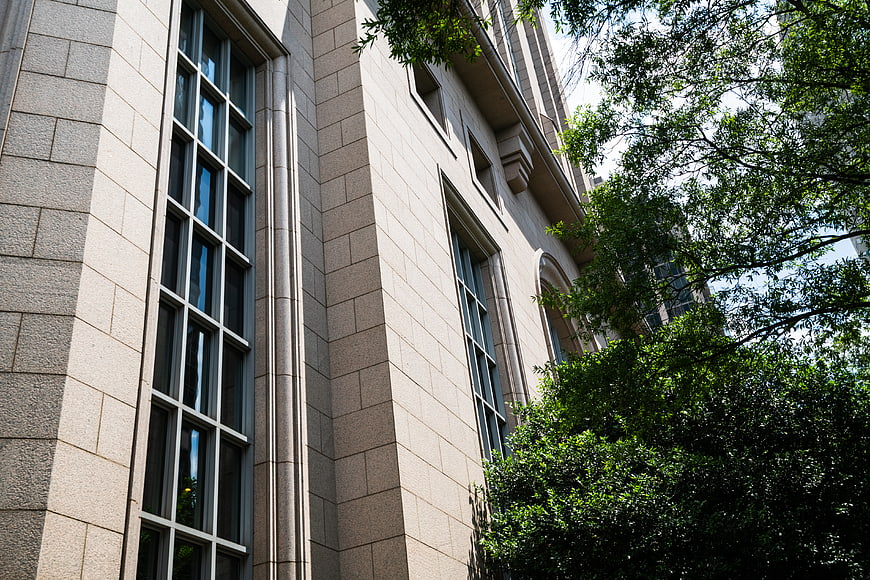 Low angle view of beige stone office building facade