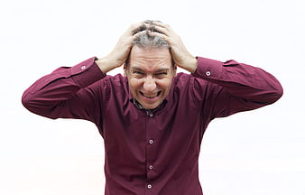 Stressed Middle-Aged Man Holding Head in Despair