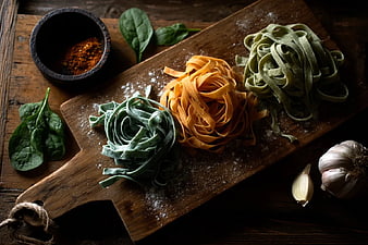 Three Colors of Fresh Pasta on Wooden Board