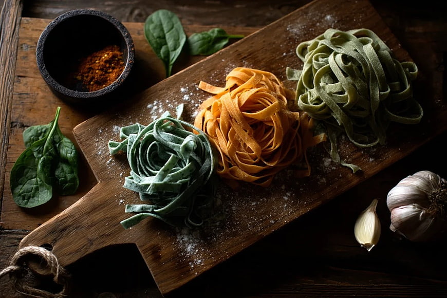 Three Colors of Fresh Pasta on Wooden Board