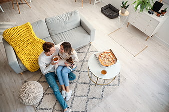 High angle view of couple eating pizza with dog at home