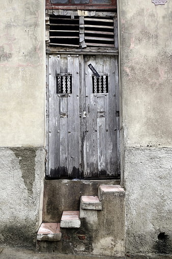 Weathered Wooden Door on Old Concrete Building