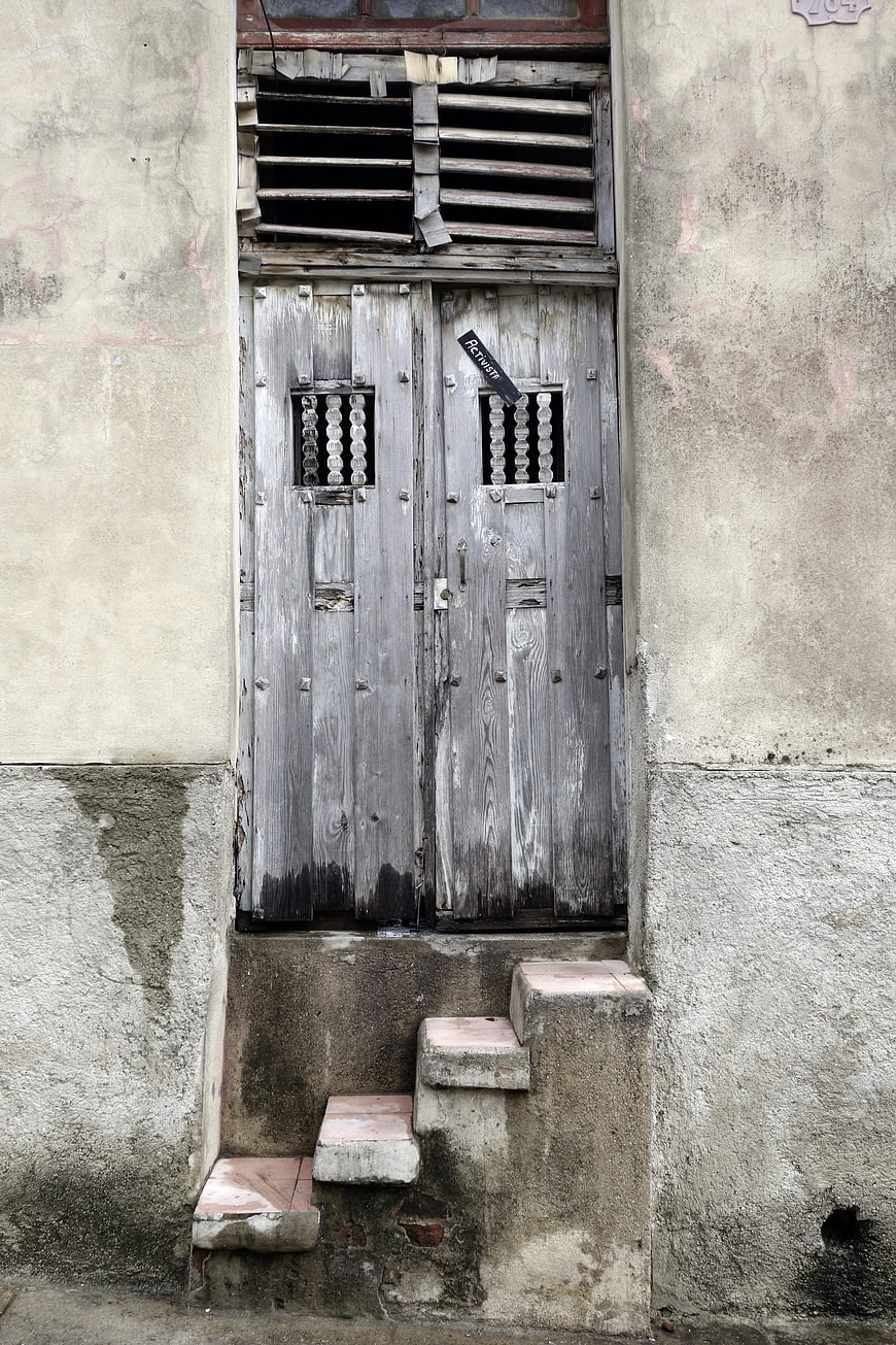Weathered Wooden Door on Old Concrete Building