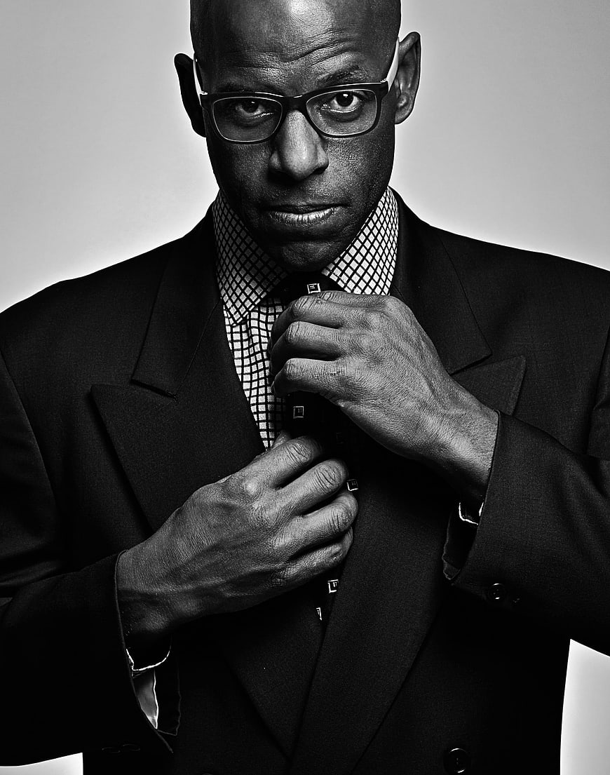 Black and white portrait of a businessman adjusting his tie