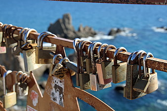 Rusty Love Locks on Coastal Railing with Ocean View