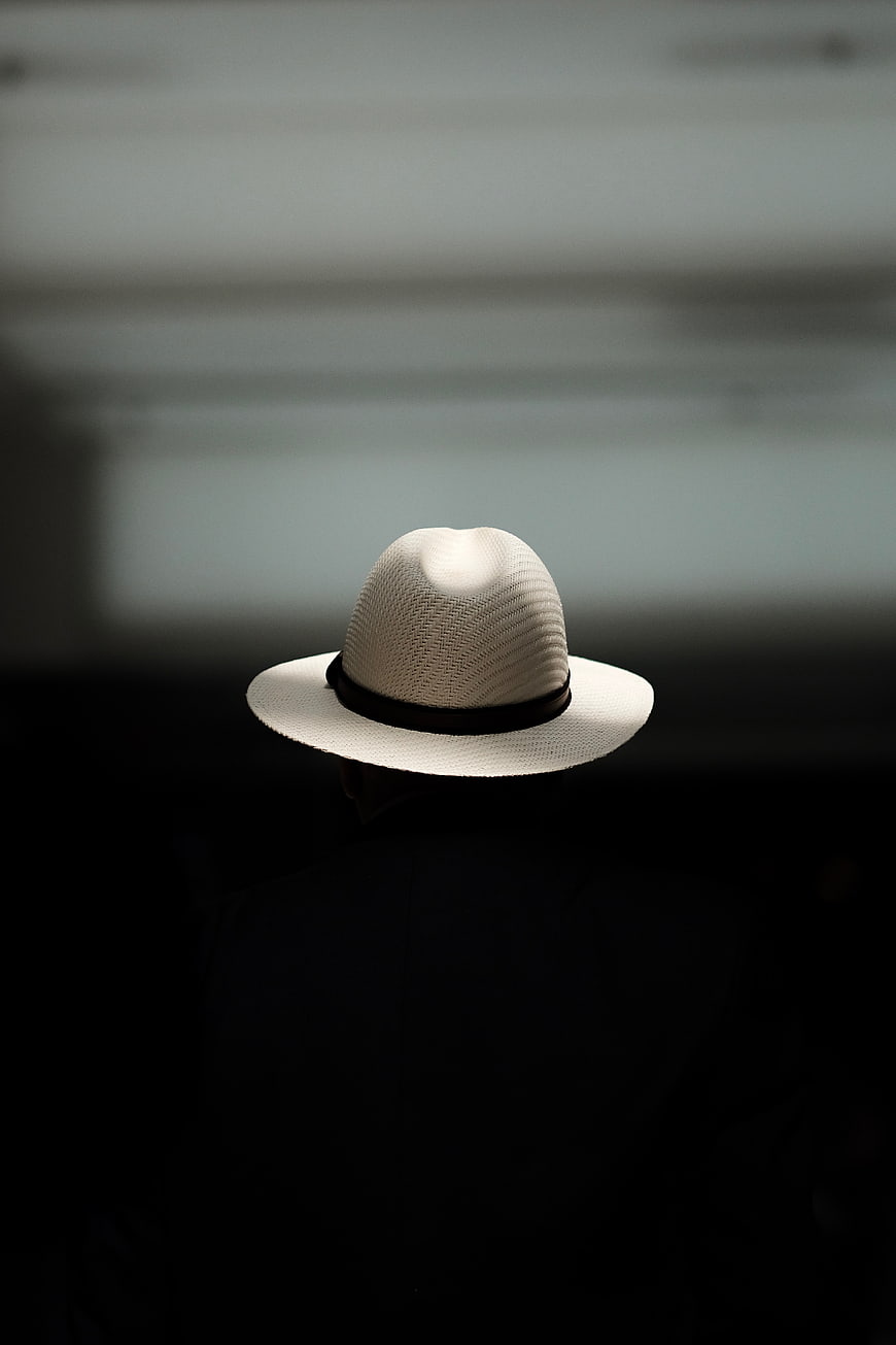 White Fedora Hat on Dark Silhouette