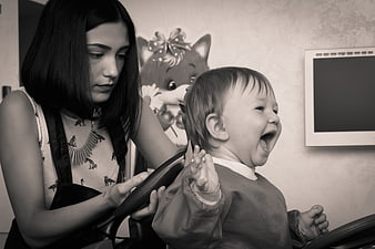 Candid Black and White Photo of a Laughing Toddler Getting a Haircut